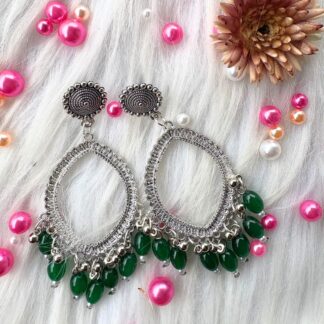 silver jhumka bezel with green beads in eyes shape