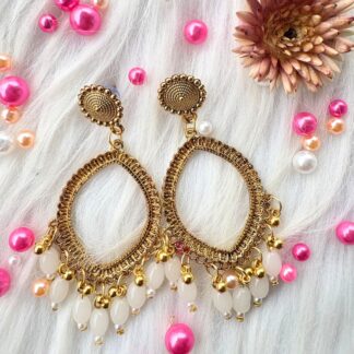 golden jhumka bezel with white beads in eyes shape